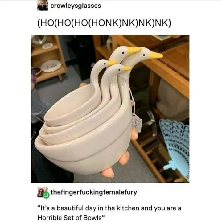 A person holds a set of four white ceramic bowls shaped like geese, stacked in descending size with yellow beaks and black…