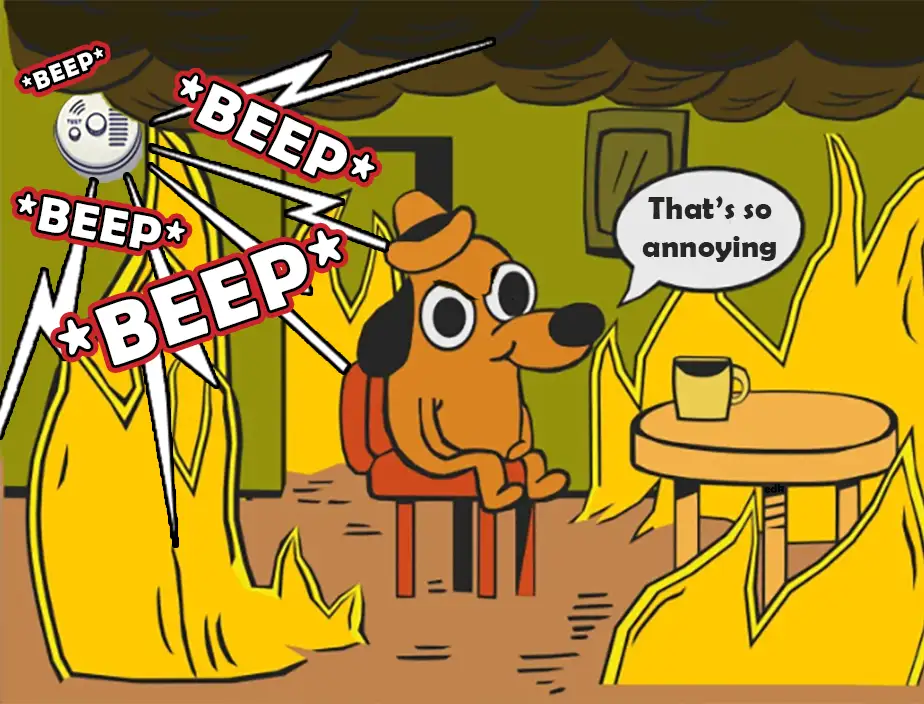 A cartoon dog wearing a hat sits calmly in a room engulfed in flames, ignoring a beeping smoke detector. Multiple '*BEEP*'…