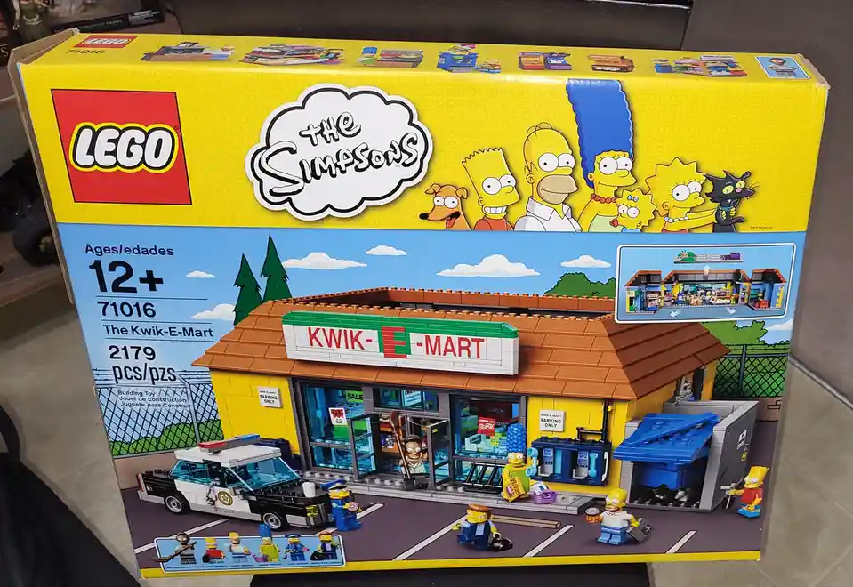 A yellow LEGO box for set 71016, 'The Simpsons: The Kwik-E-Mart,' shows a detailed LEGO model of the iconic store with…