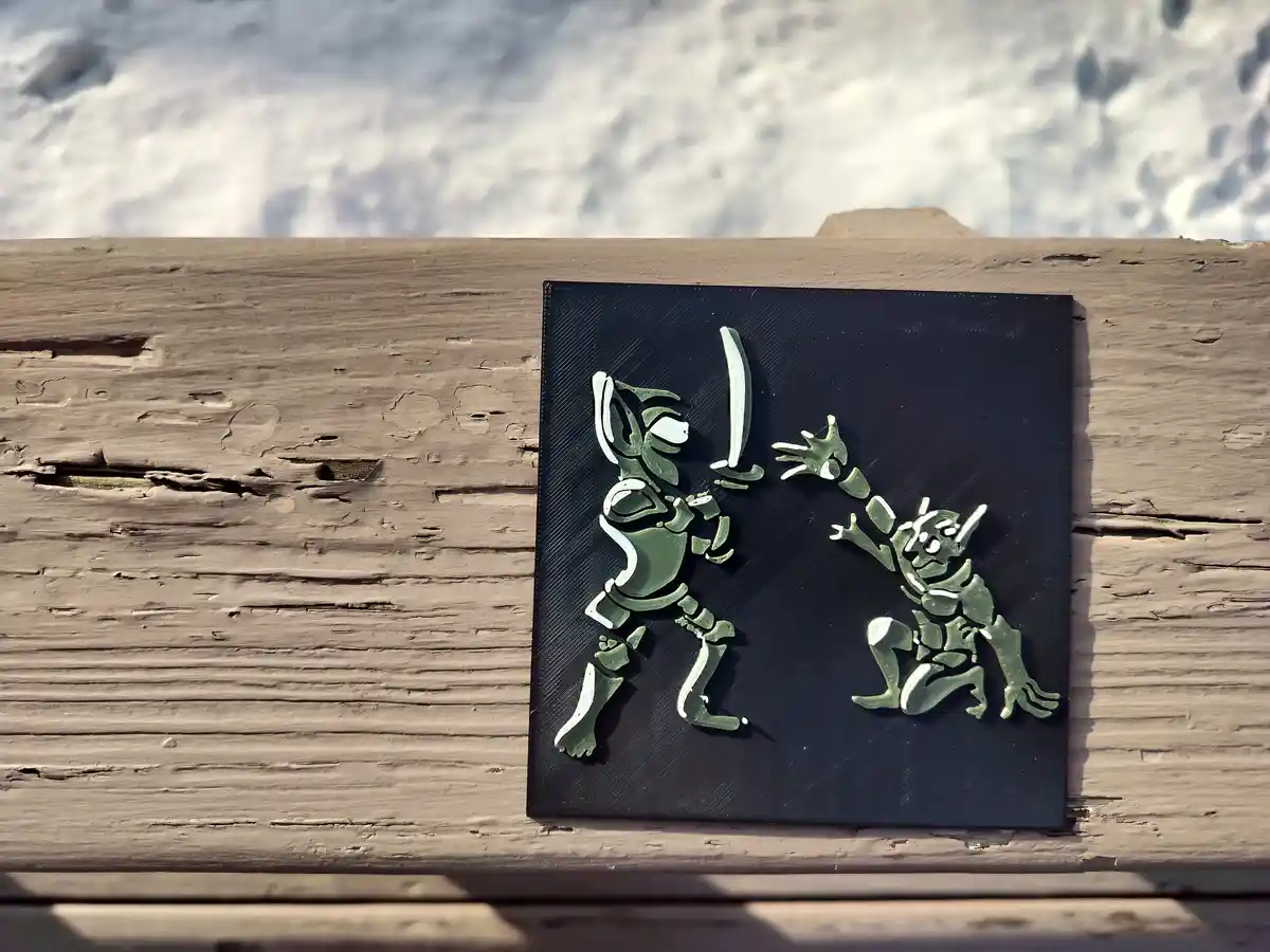 A 3D-printed green and white figurine depicts a stylized warrior in a dynamic fighting pose, wielding a sword against a…
