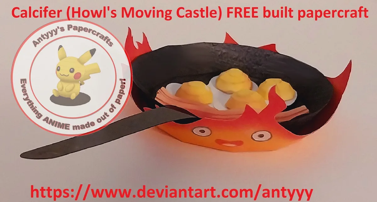 A 3D paper craft of Calcifer from Howl's Moving Castle, depicted as a smiling orange flame with red spikes, holding a black…
