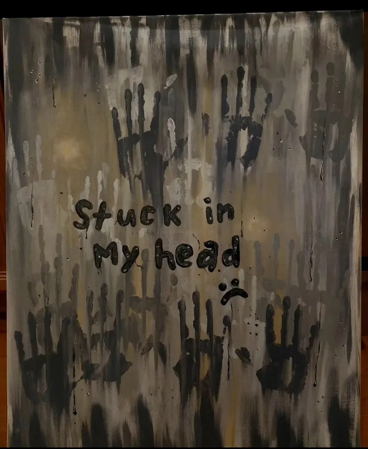 A textured, abstract painting with dark gray and beige drips and smudges, featuring multiple black handprints. Overlaid text…