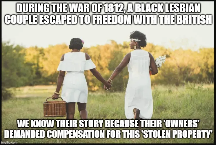 Two Black women in white dresses walk hand-in-hand through a grassy field, one carrying a wicker picnic basket and the other…