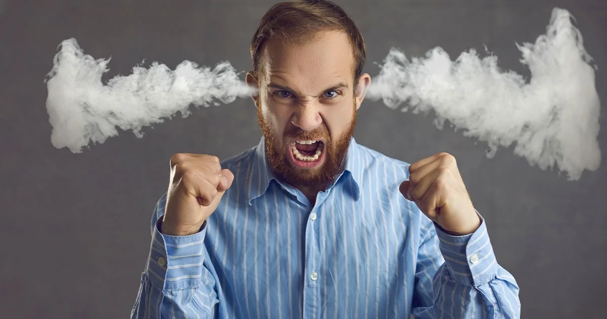 a man with a beard and blue striped shirt is screaming with his fists clenched, white smoke visibly billowing from both…