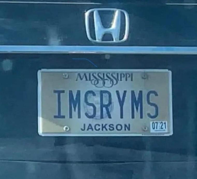 A close-up photo of a Mississippi license plate on a dark Honda car, showing the plate number 'IMSRYMS' and the city…