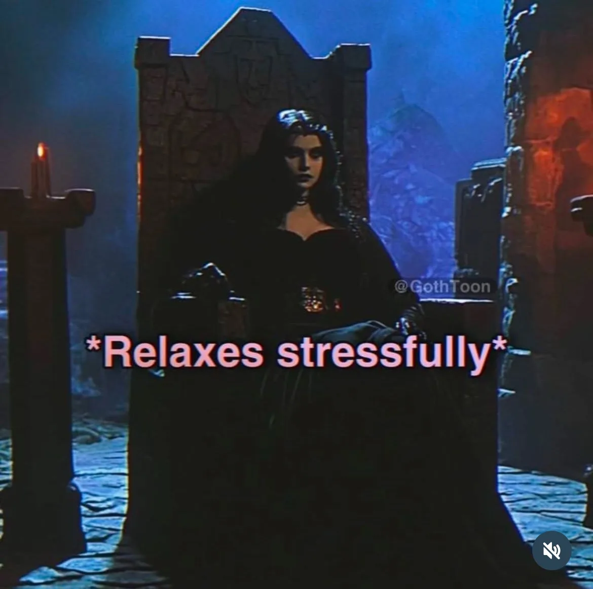 A woman in a dark, gothic gown sits regally on a stone throne in a dimly lit, castle-like room with blue and orange…