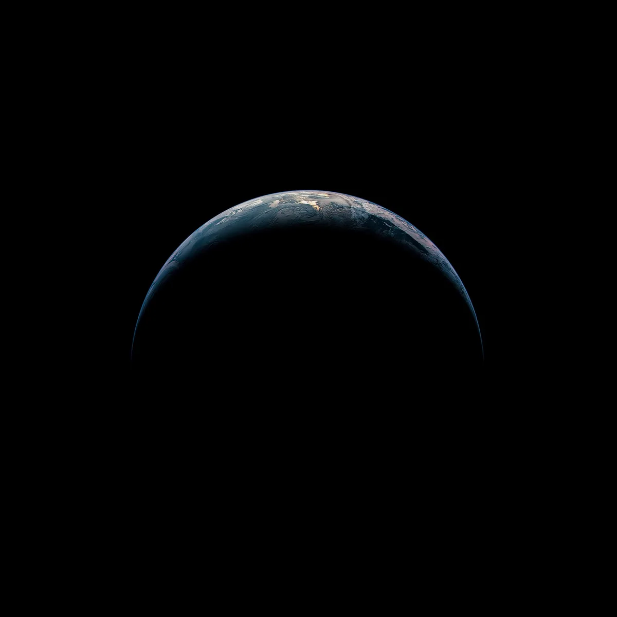 A view of Earth from space, showing the planet's curved horizon with visible continents and oceans against the blackness of…
