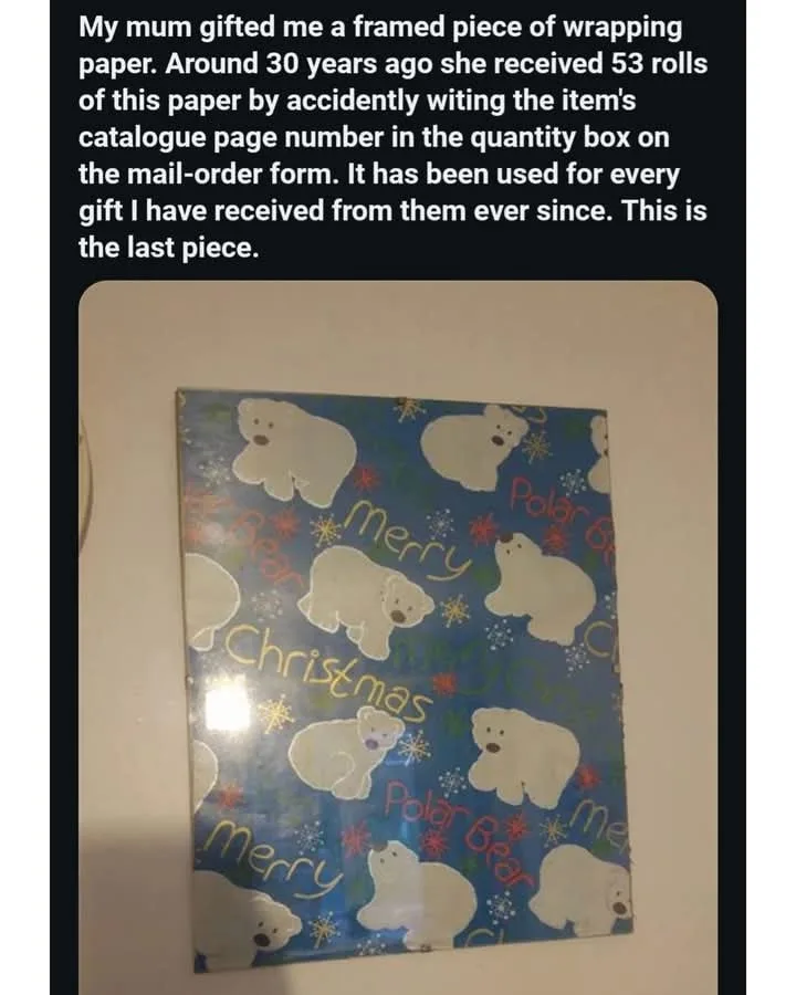 A framed piece of blue Christmas wrapping paper featuring white polar bears and the words 'Merry Christmas' and 'Polar Bear'…