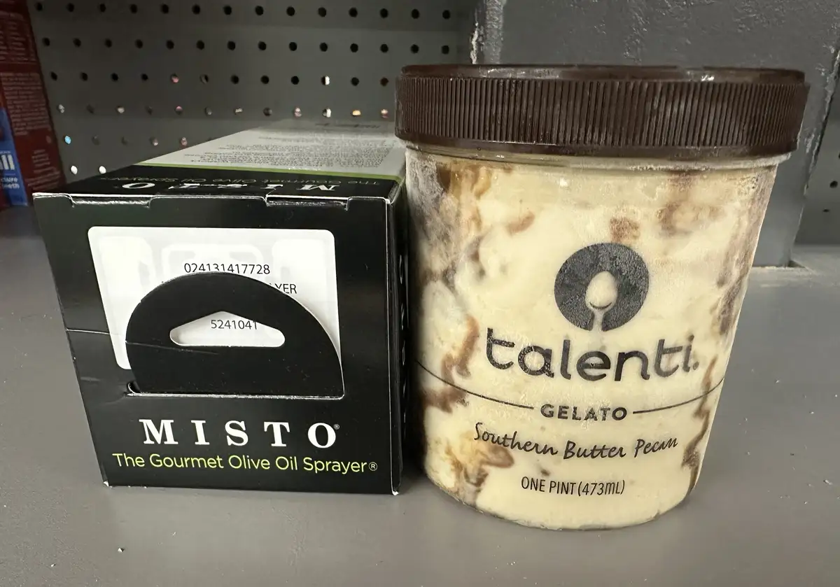 A pint of Talenti Southern Butter Pecan gelato sits next to a box of Misto The Gourmet Olive Oil Sprayer on a store shelf…