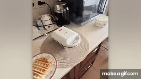 A sequence of images shows a white waffle maker on a kitchen counter next to a plate with a cooked waffle. In the final…