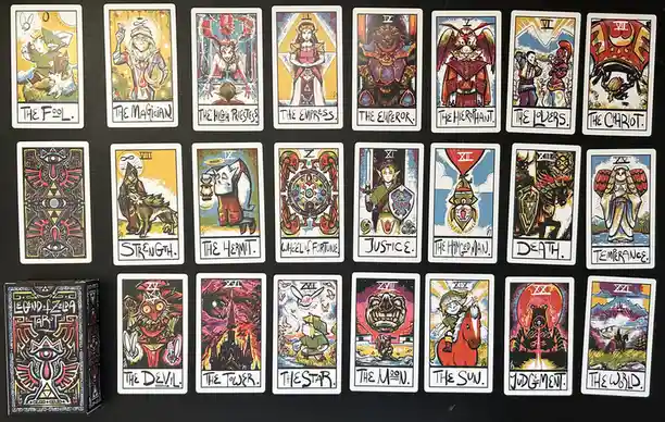 An image displays a custom 'Legend of Zelda Tarot' deck, with 22 cards arranged in three rows on a black surface. Each card…