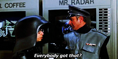 A composite image showing a scene from the movie 'The Naked Gun' with two men in futuristic uniforms. One man, wearing a…