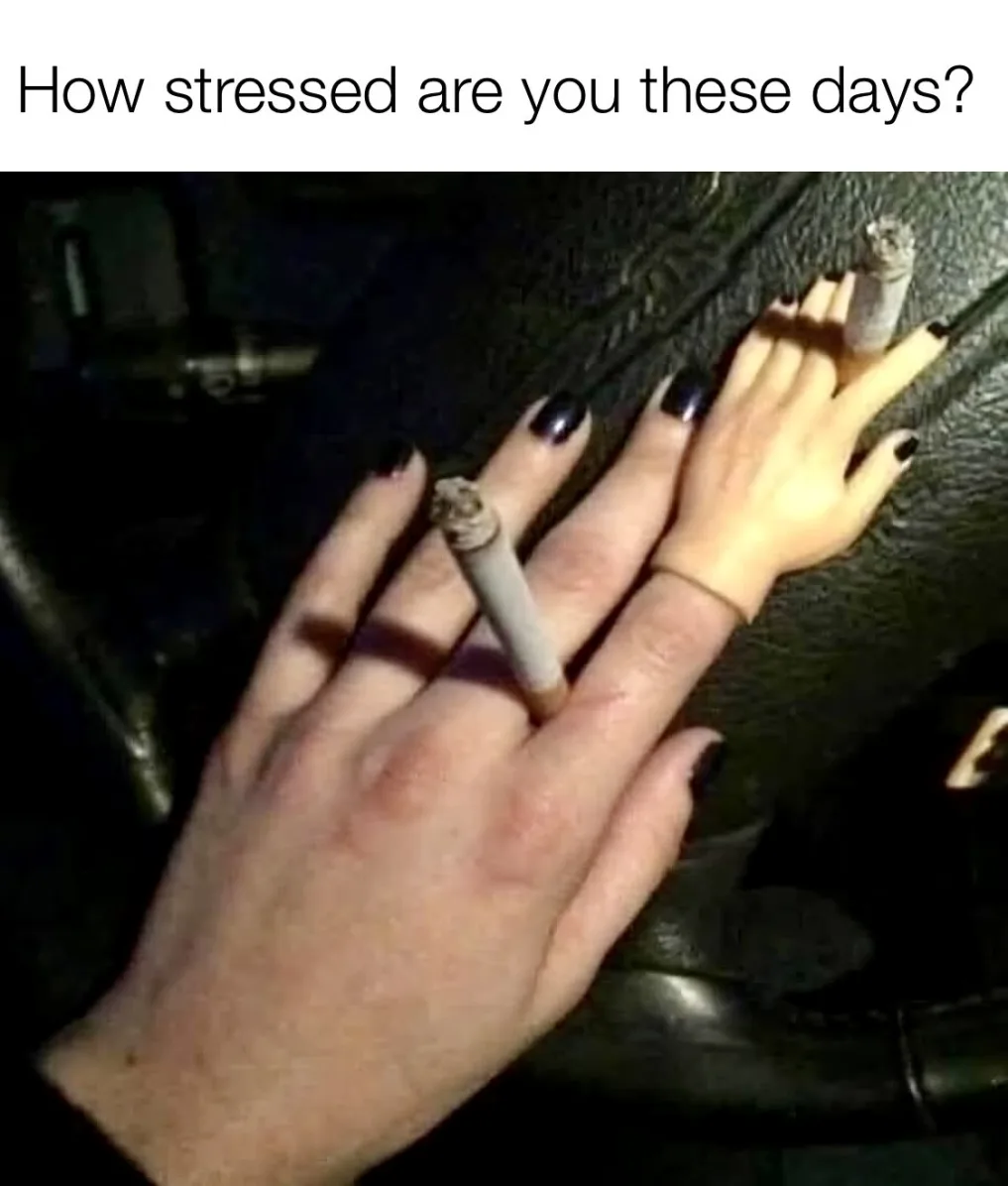 A close-up image shows a person's hand with black nail polish resting on a dark, textured surface, likely a car interior. A…
