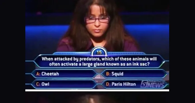 A woman wearing glasses is shown on a game show screen with a multiple-choice question asking which animal activates an ink…