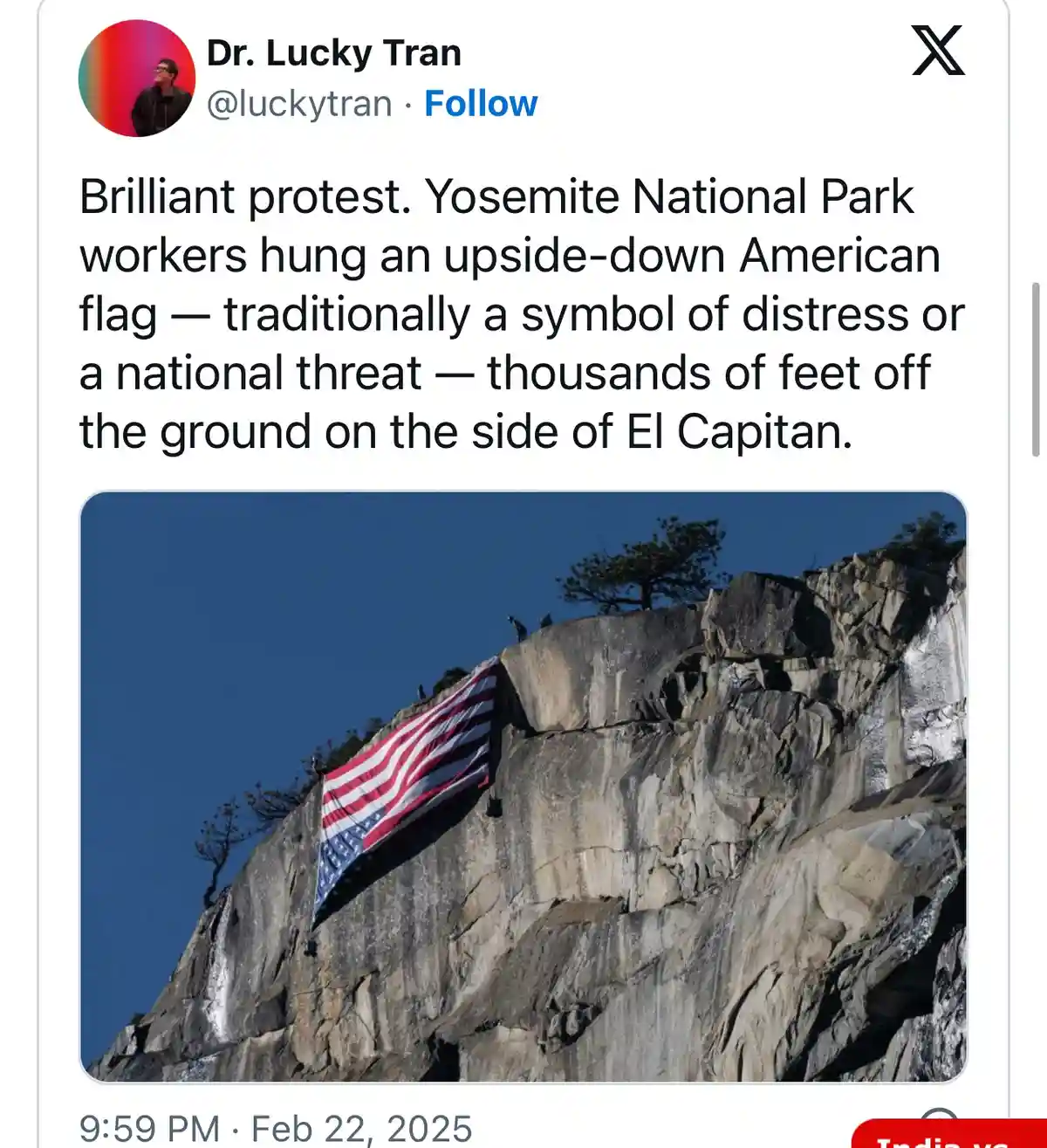 An upside-down American flag is visibly hung on the sheer rock face of El Capitan in Yosemite National Park, with a clear…