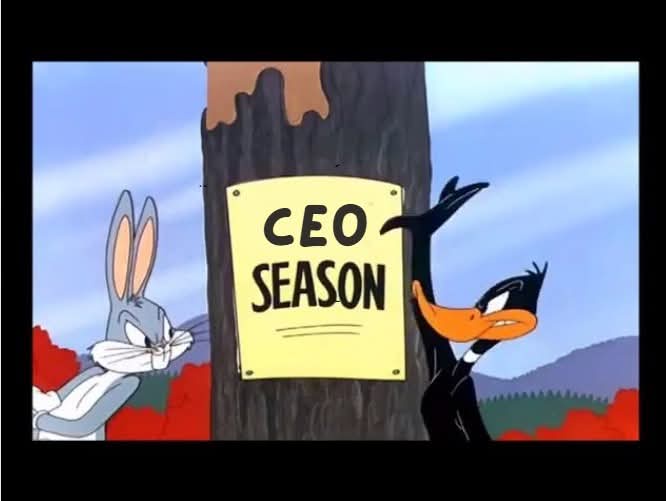 In a classic Looney Tunes cartoon scene, Bugs Bunny stands to the left looking annoyed, while Daffy Duck, on the right…