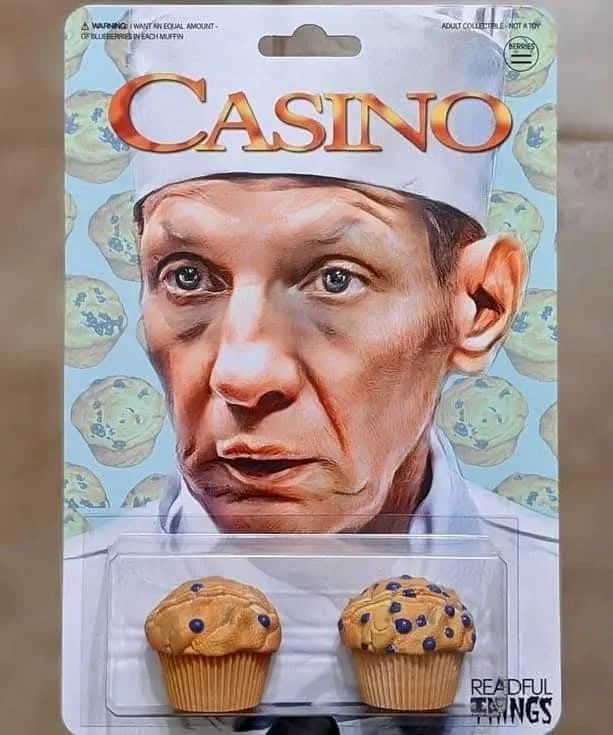 A toy package parodying the movie 'Casino' features a close-up of actor Robert De Niro wearing a chef's hat, with blueberry…