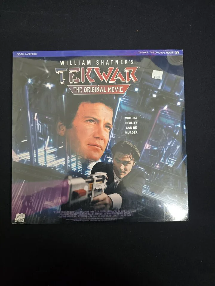 A digital laserdisc cover for William Shatner's TekWar, featuring Shatner's face prominently and another man aiming a…