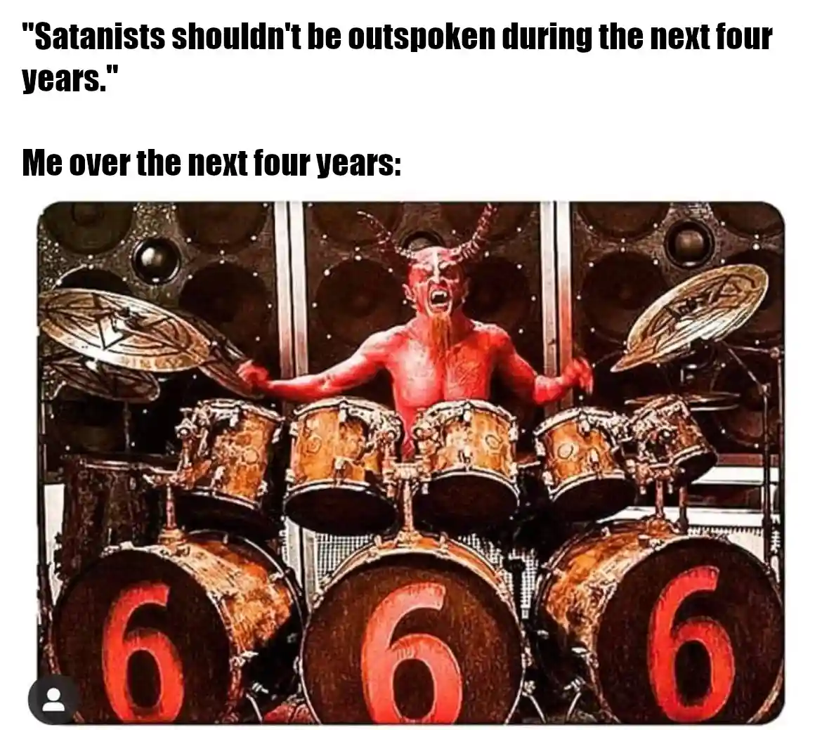 A red-skinned devil with horns and a beard is energetically playing a large drum set. The drums in the foreground…
