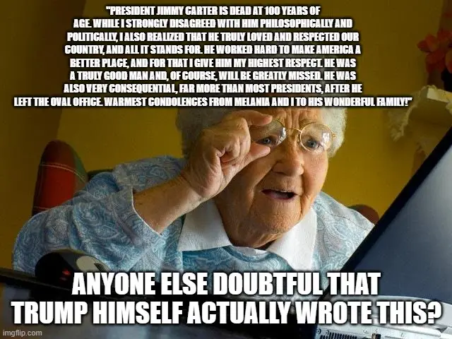 An elderly woman with glasses, wearing a blue patterned shirt, is shown looking at a laptop screen with a skeptical or…