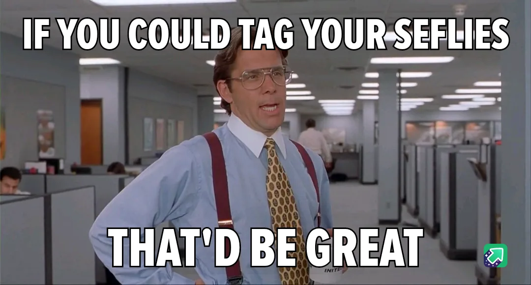 A man in glasses, a light blue shirt, and red suspenders stands in an office with his hands on his hips, looking…