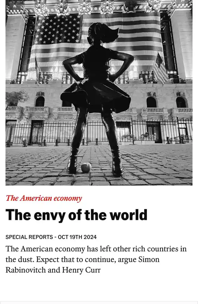 A black-and-white photo shows the 'Fearless Girl' statue standing confidently with hands on hips, facing a large American…