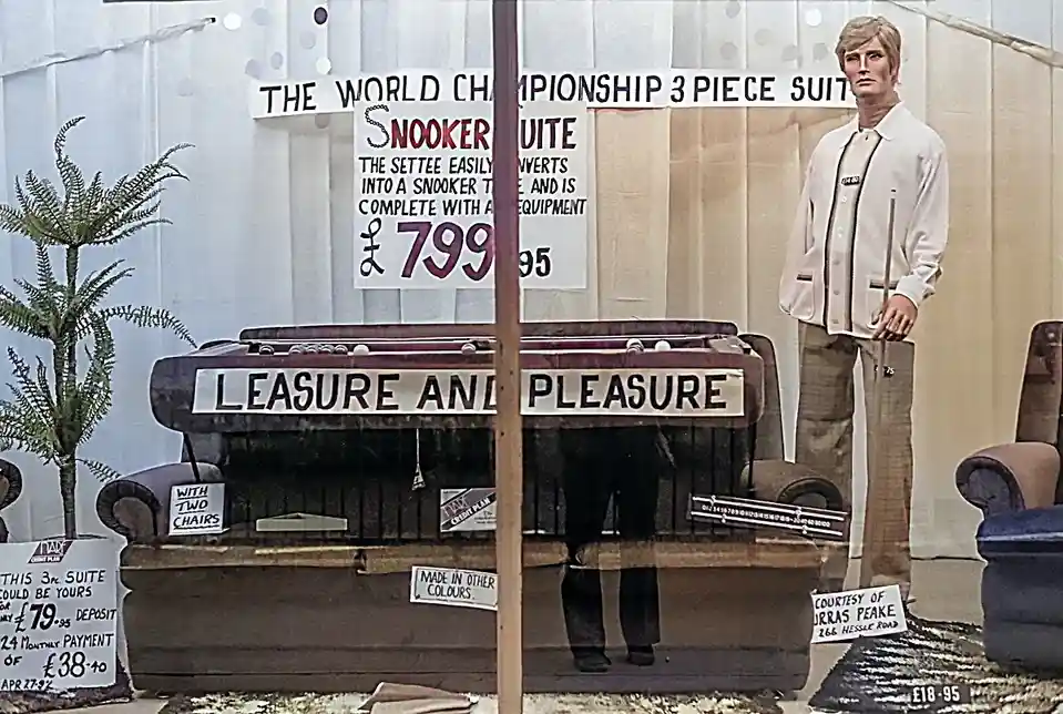A vintage furniture store display features a sofa that converts into a snooker table, labeled 'THE WORLD CHAMPIONSHIP 3…