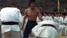 A sequence of six stills from a martial arts movie shows a shirtless man in black pants defeating multiple opponents in…