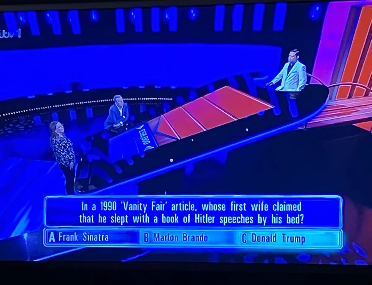 A screenshot from the game show 'The Chase' shows a contestant facing a question on a blue screen. The question asks, 'In a…