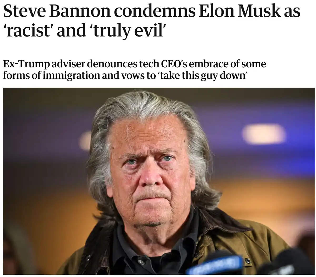 A close-up photo of Steve Bannon with a stern, intense expression, wearing a dark jacket over a collared shirt, with…