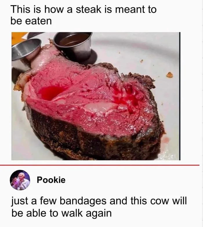 A close-up photo shows a thick, sliced steak with a very rare, bloody center on a white plate, accompanied by two small…