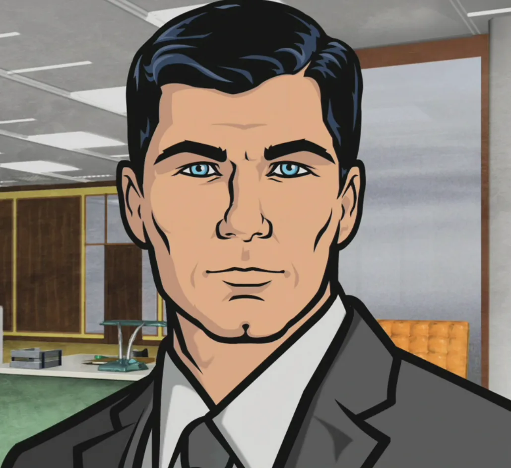 A cartoon-style image shows a man with blue eyes and dark hair wearing a gray suit and tie, sitting in an office with…