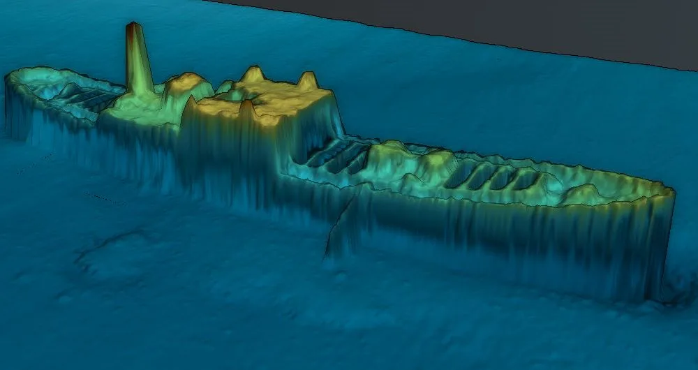 A 3D sonar-style underwater map shows the submerged, broken hull of a shipwreck with visible deck structures and a…