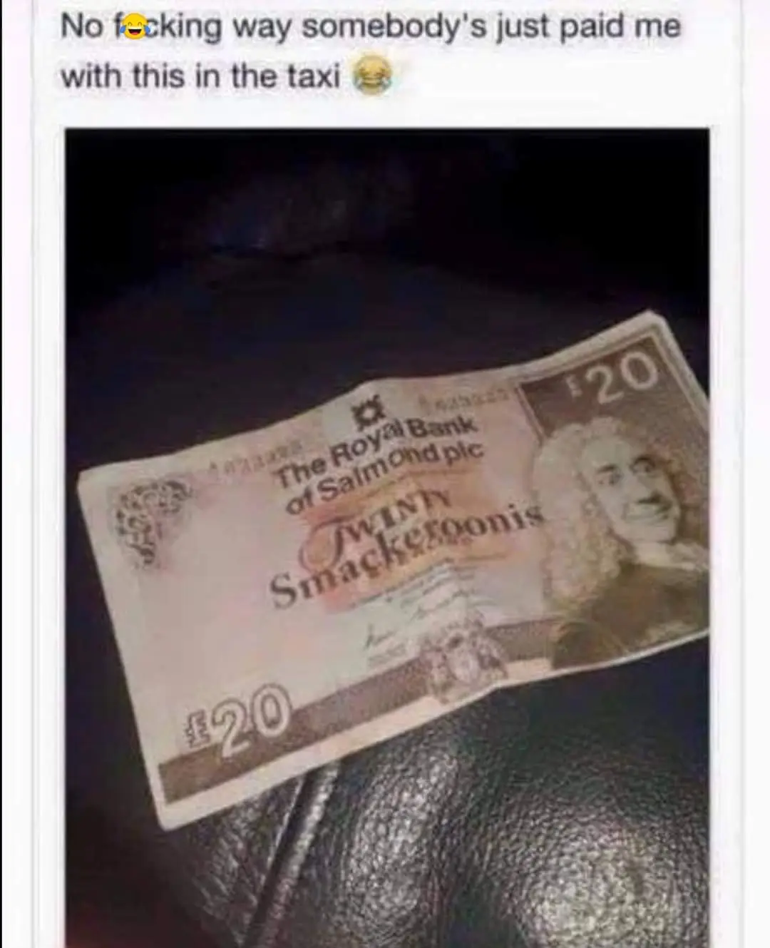 A close-up photo shows a fake £20 banknote resting on a dark, textured surface, likely a car seat. The note is humorously…