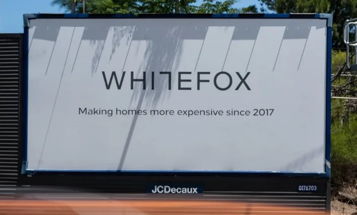 A large outdoor billboard displays the brand name 'WHITEFOX' in bold black letters, with the tagline 'Making homes more…