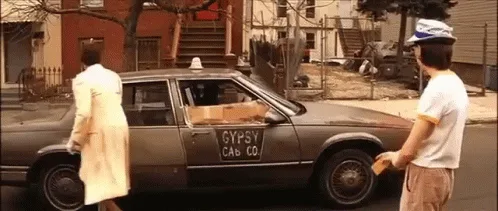 A sequence of frames shows a woman in a beige coat opening the door of a dark gray taxi labeled 'GYPSY CAB CO.' A young man…