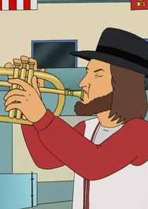 A cartoon man with long brown hair, a beard, and a black fedora is playing a golden trumpet. He wears a red cardigan over a…