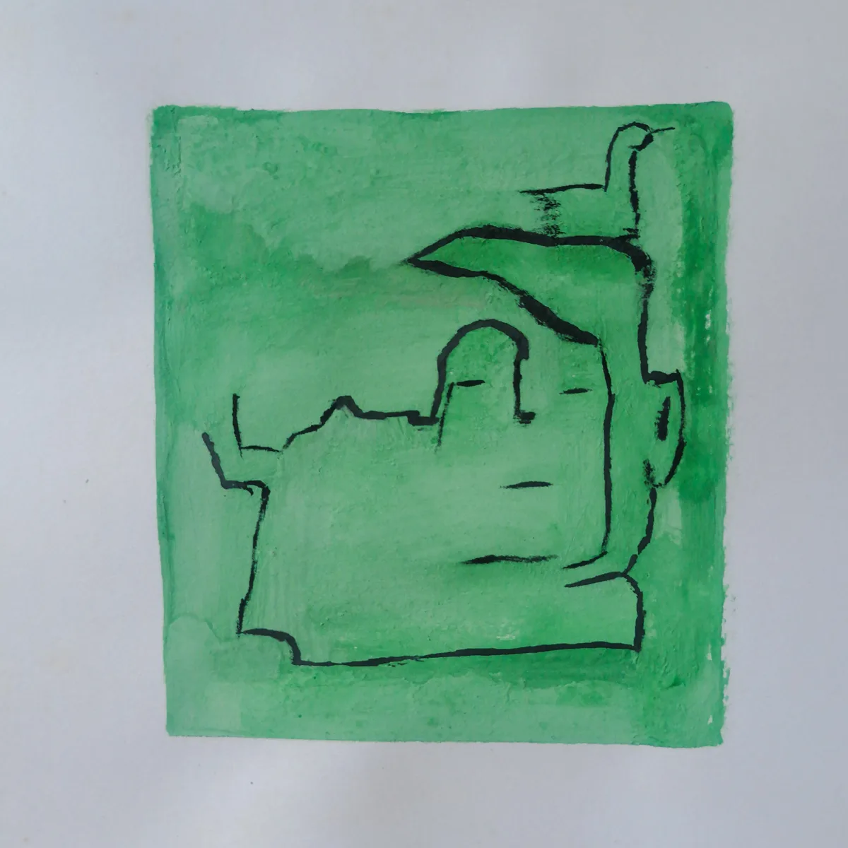 A simple green watercolor painting shows a crudely drawn face with closed eyes and a neutral expression, outlined in black…