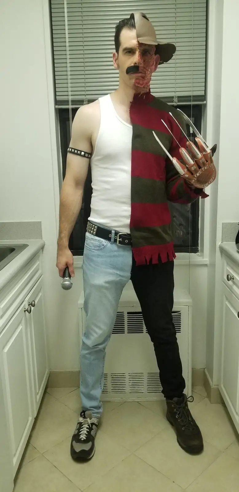 A man stands in a kitchen, split vertically down the middle. His left side shows him in casual clothes: white tank top…