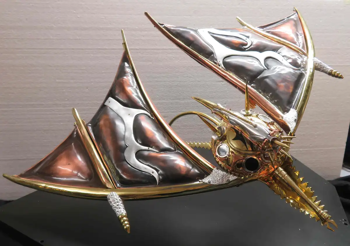 a highly detailed steampunk dragon sculpture made of copper, brass, and silver metal, featuring large bat-like wings with…