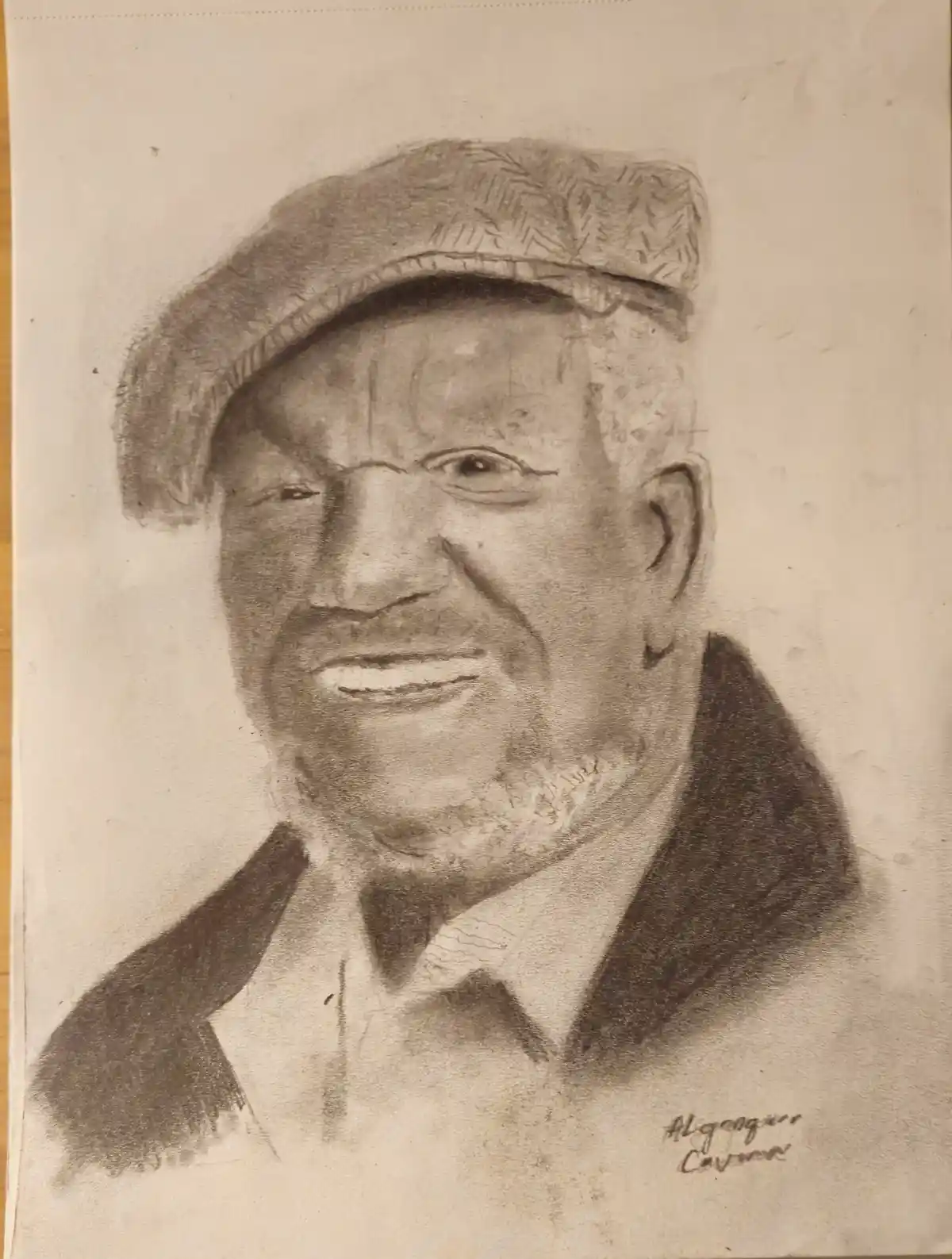 A pencil sketch of an elderly Black man wearing a flat cap and collared shirt, smiling warmly. The artist's signature…