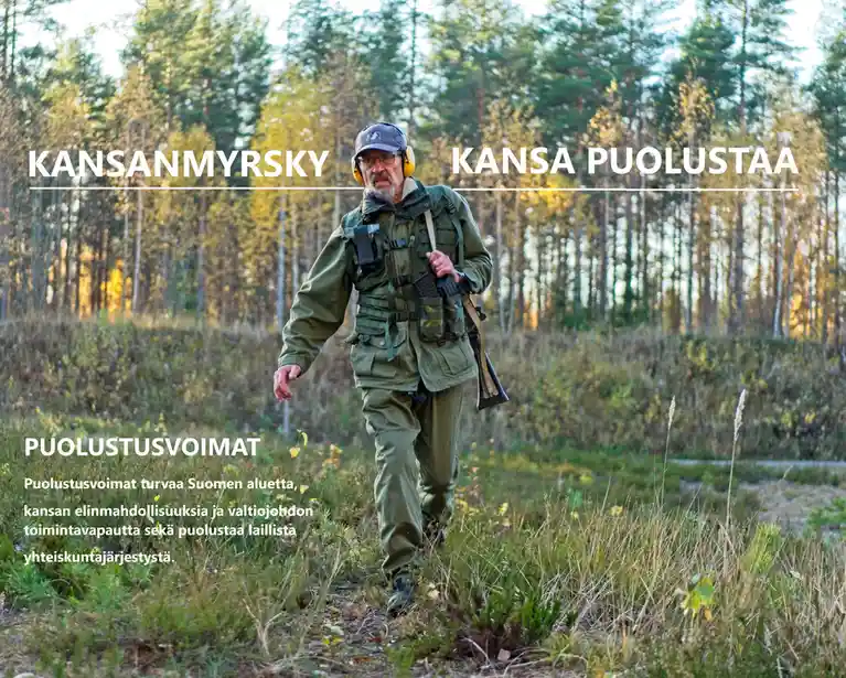 A man in military-style gear walks through a forest with text overlaid. The text reads 'KANSANMYRSKY KANSA PUOLUSTAA' above…