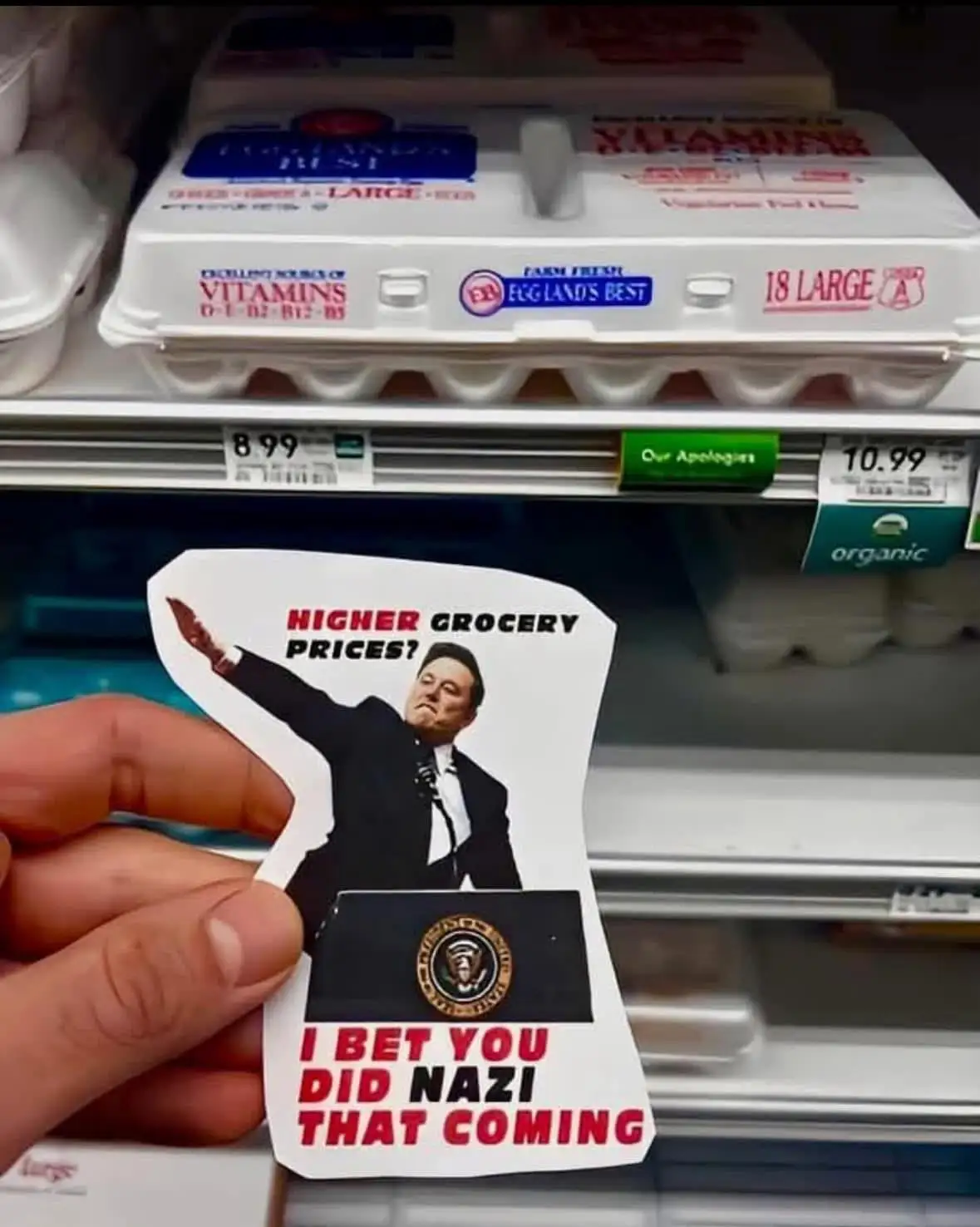 A hand holds a cutout image of a man in a suit at a podium with the presidential seal, overlaid with text asking 'HIGHER…