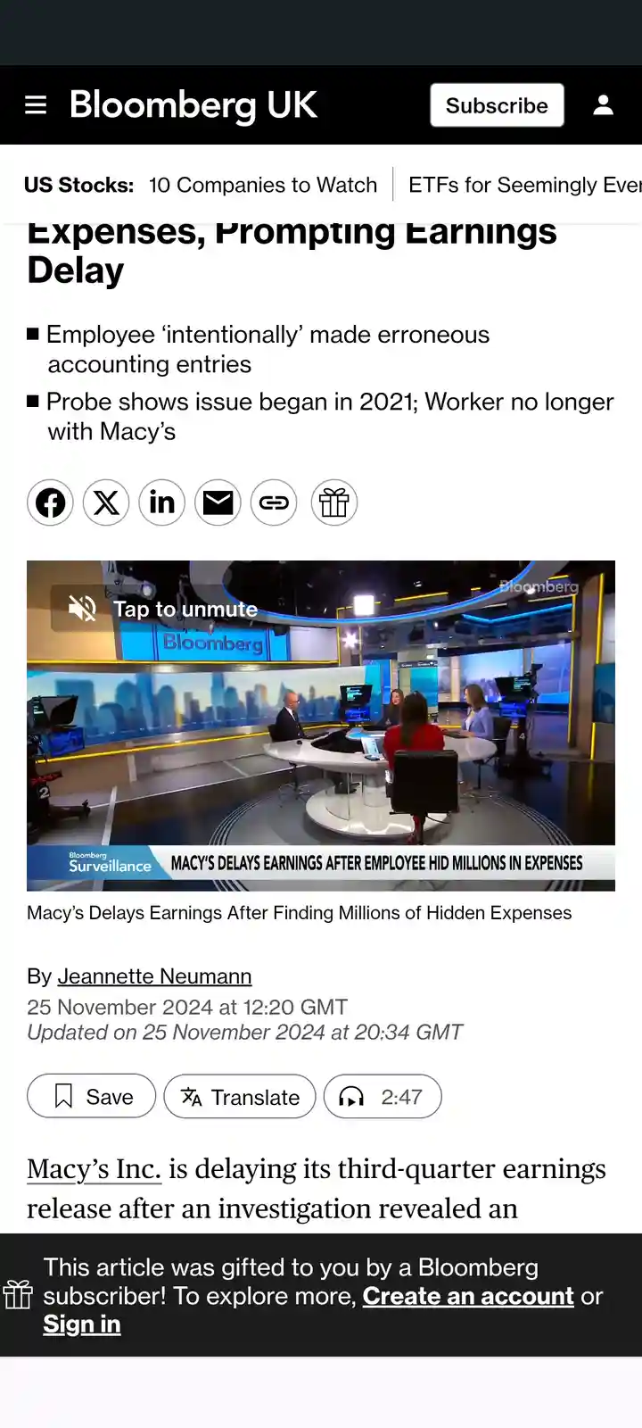 A screenshot of a Bloomberg UK news article about Macy's delaying earnings due to hidden expenses. The article headline and…
