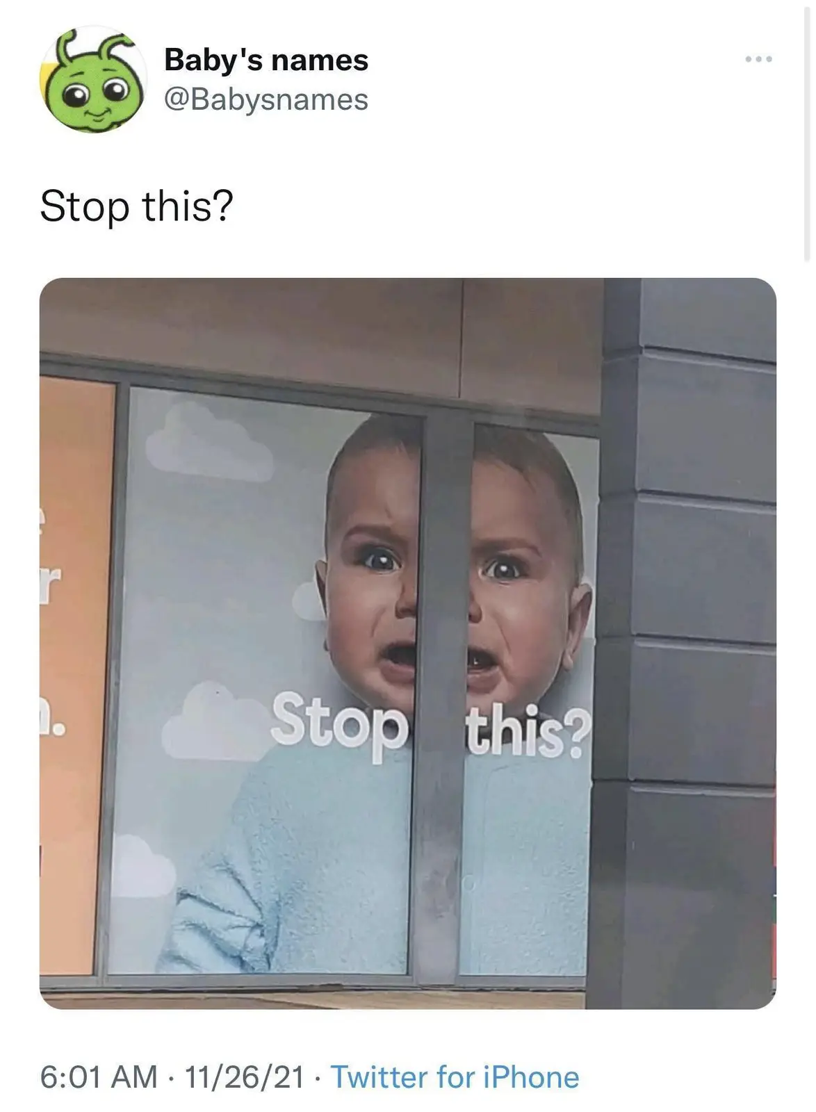 A large advertisement poster of a crying baby is split vertically by a window frame, with the text 'Stop this?' overlaid on…