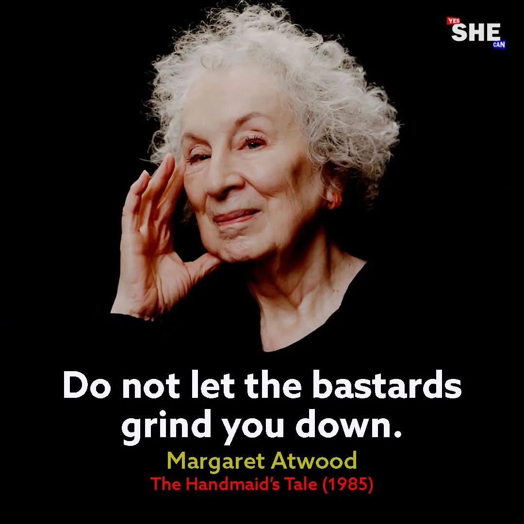 An image of Margaret Atwood, an elderly woman with white curly hair, smiling gently while touching her cheek with her hand…
