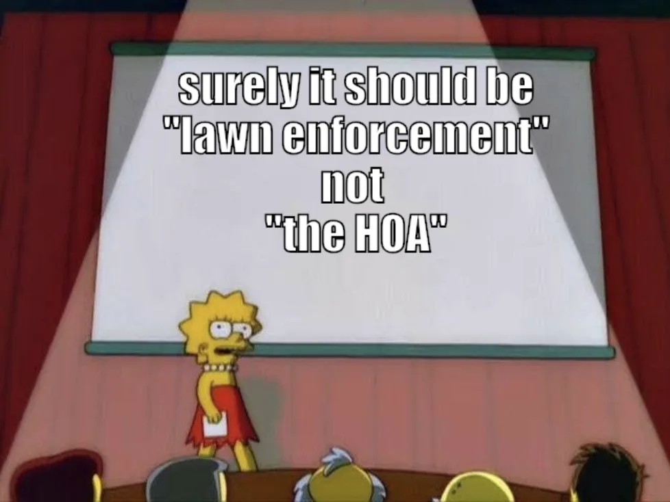 A still from The Simpsons shows Lisa Simpson standing at a podium in front of a projector screen, looking annoyed as she…