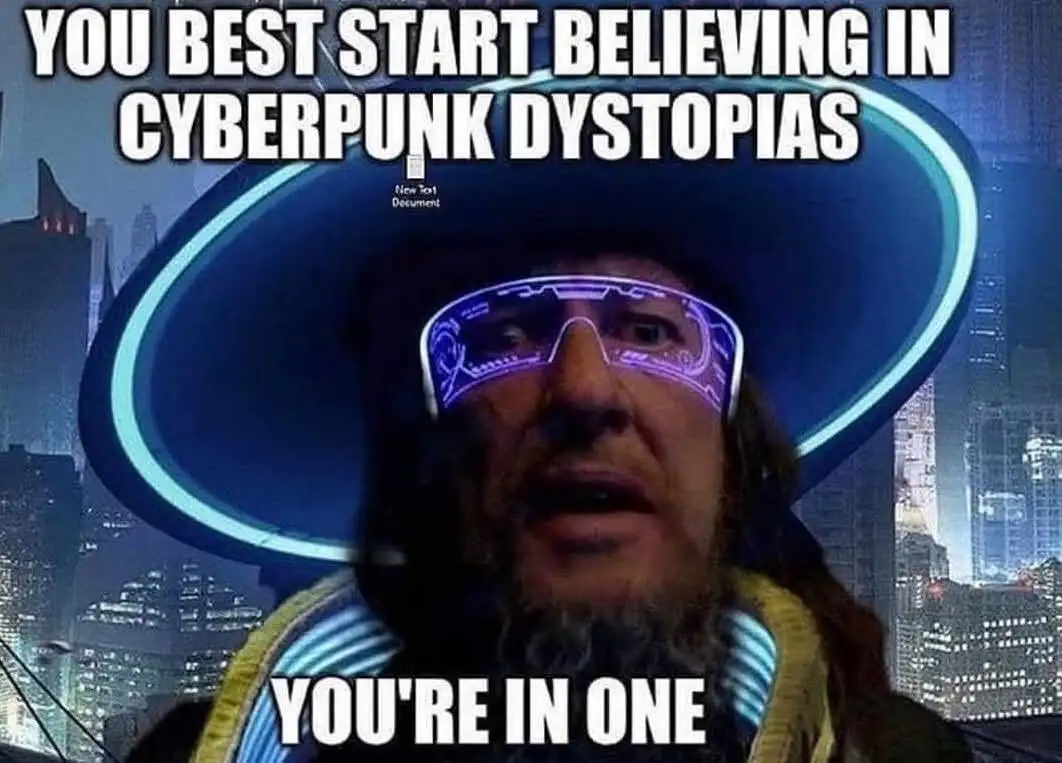 A man with a beard and futuristic glowing glasses wears a large blue hat against a city skyline. The text overlaid reads…
