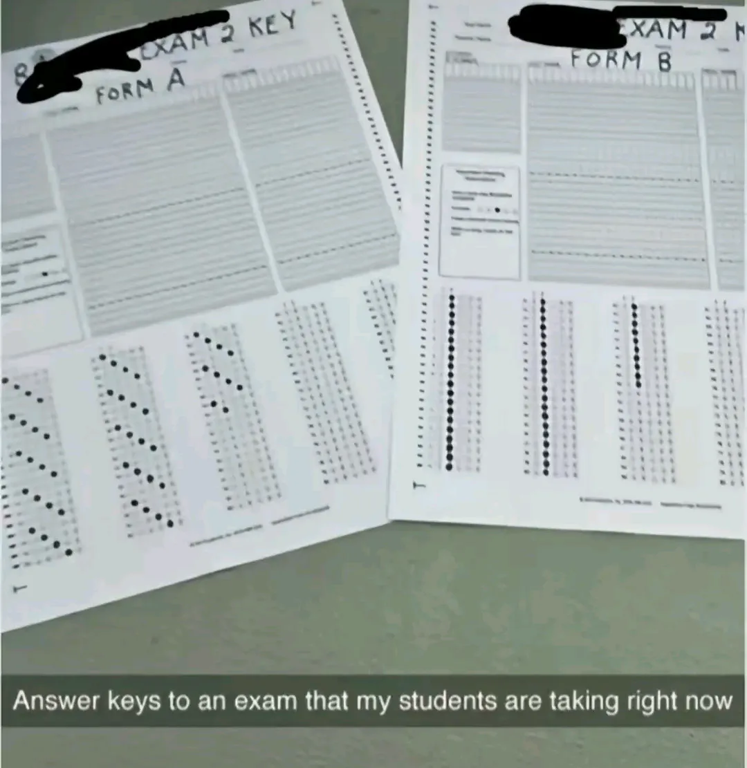 Two printed exam answer keys labeled 'FORM A' and 'FORM B' are laid out on a desk, showing bubble sheets with filled-in…