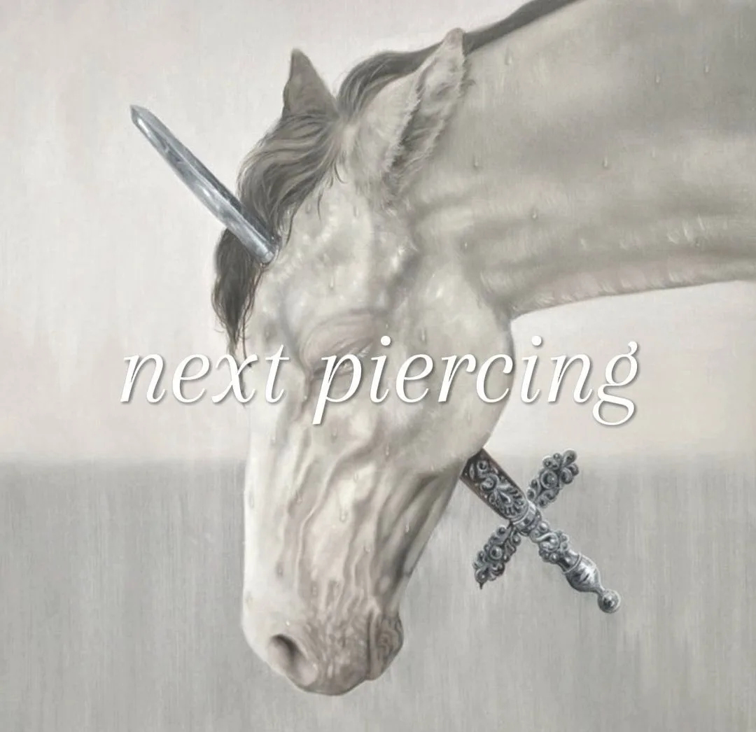 A grayscale painting of a unicorn's head with a sword piercing its forehead, and another sword piercing its mouth, overlaid…